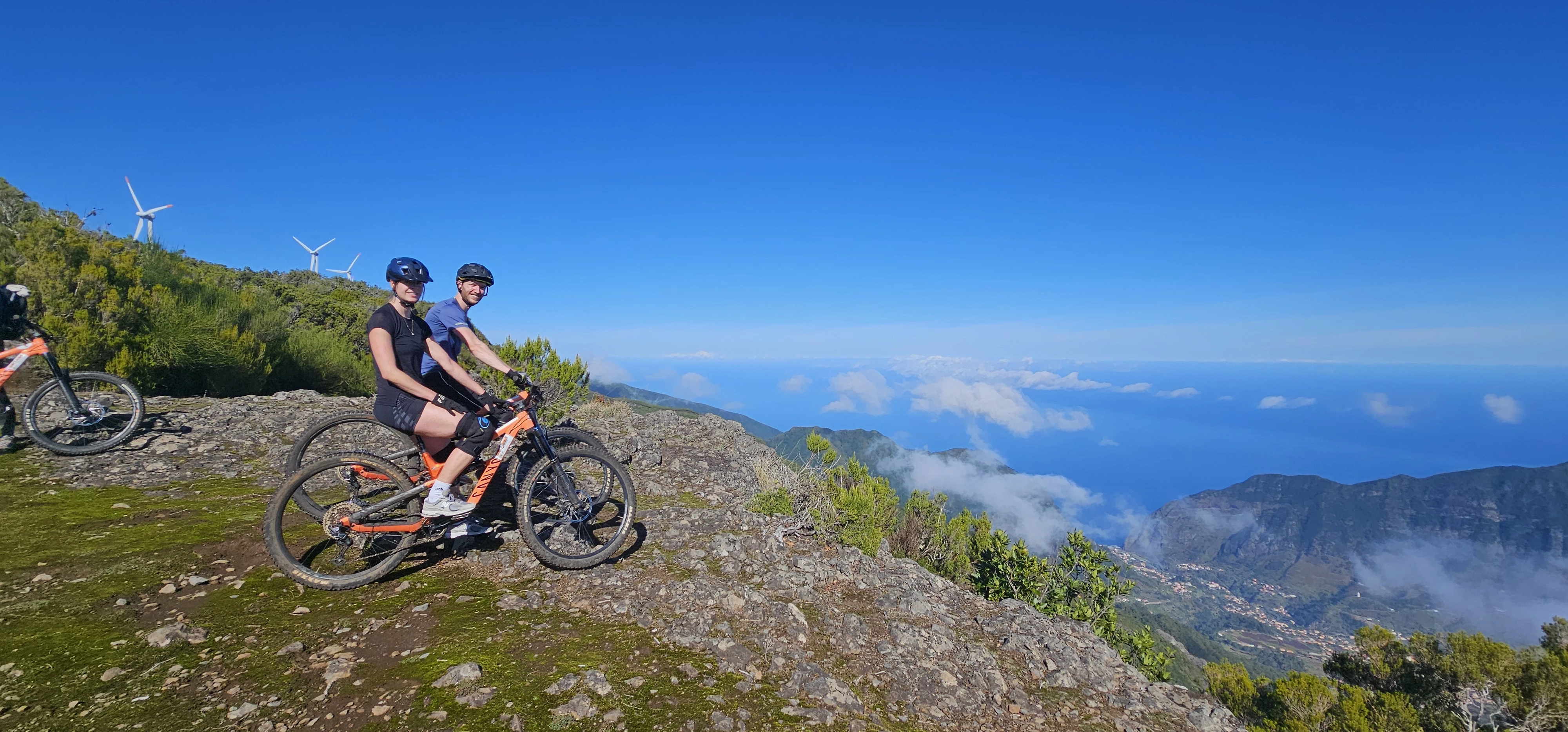 Family cycling on trails with their bikes in Madeira.